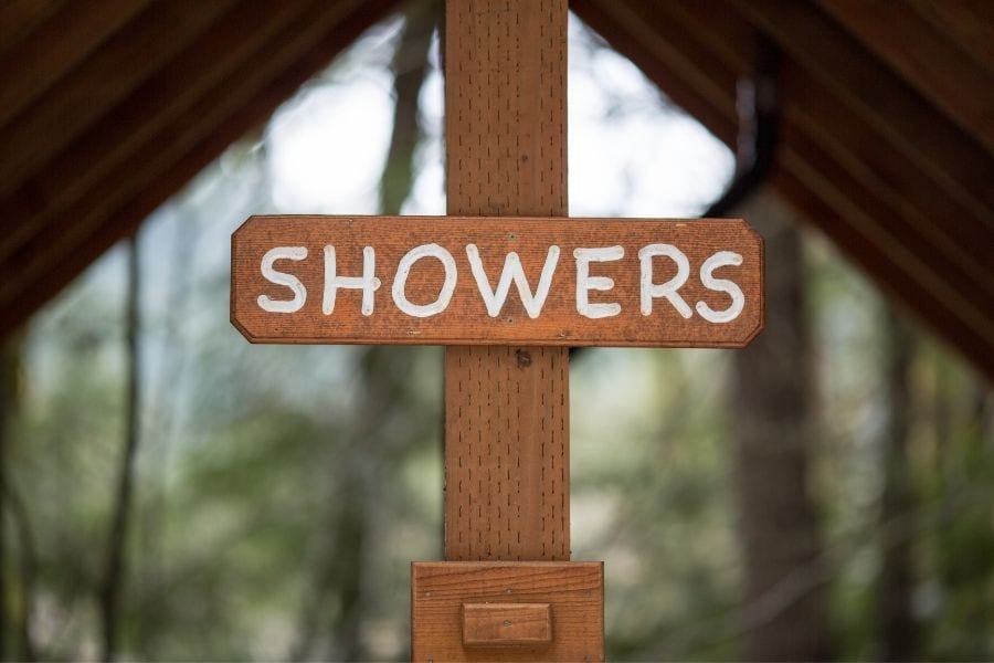 A sign marks the building for showers in a campground